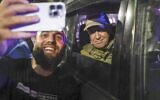 Yevgeny Prigozhin, the owner of the Wagner Group military company, right, sits inside a military vehicle posing for a selfie photo with a local civilian on a street in Rostov-on-Don, Russia, June 24, 2023, prior to leaving an area of the headquarters of the Southern Military District. (AP Photo)