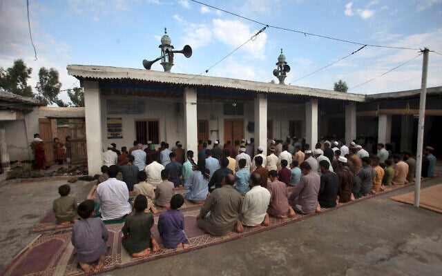 Afghan refugees attend Eid al-Adha prayers at a mosque in the Kazana Refugees camp on the outskirts of Peshawar, Pakistan, June 28, 2023. (AP Photo/Muhammad Sajjad)