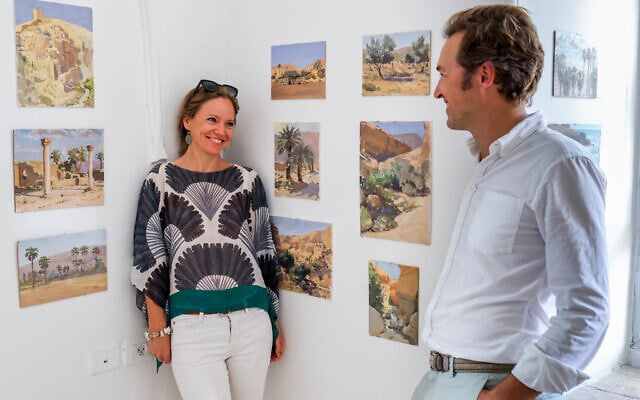 Painter Lotta Camilla Teale, her husband, Skye Christensen, and her figurative oil paintings from 'Jerusalem: An Exhibition,' marking a year of living in the city (Courtesy Mattias Somm)