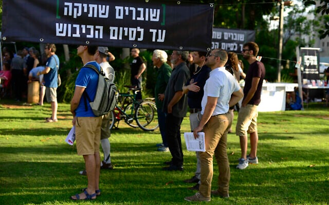 Left-wing NGO Breaking the Silence holds an event in Tel Aviv on July 1, 2017 where testimonies of former soldiers stationed in the West Bank were read aloud in front of the Kirya military base. The sign reads: 'Breaking the silence until the occupation ends.' (Tomer Neuberg/Flash90) Left-wing NGO Breaking the Silence holds an event in Tel Aviv on July 1, 2017 where testimonies of former soldiers stationed in the West Bank were read aloud in front of the Kirya military base. The sign reads: 'Breaking the silence until the occupation ends.' (Tomer Neuberg/Flash90)