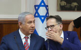 Prime Minister Benjamin Netanyahu (L) speaks with then-Cabinet Secretary Tzachi Braverman during the weekly government conference at the Prime Minister's Office in Jerusalem on June 17, 2018. (Marc Israel Sellem/POOL)