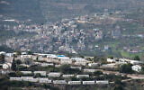 A neighborhood in the West Bank settlement of Eli overlooking a nearby Palestinian village, January 17, 2021. (Sraya Diamant/Flash90)