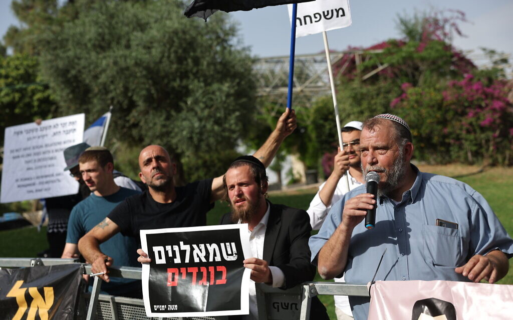 Extremist Lehava head Bentzi Gopstein (with microphone) and other far-right activists demonstrate against the annual Pride Parade in Jerusalem, on June 1, 2023. (Yonatan Sindel/Flash90)