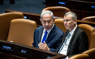 Prime Minister Benjamin Netanyahu, left, with Justice Minister Yariv Levin at the Knesset in Jerusalem, on June 7, 2023. (Oren Ben Hakoon/Flash90)