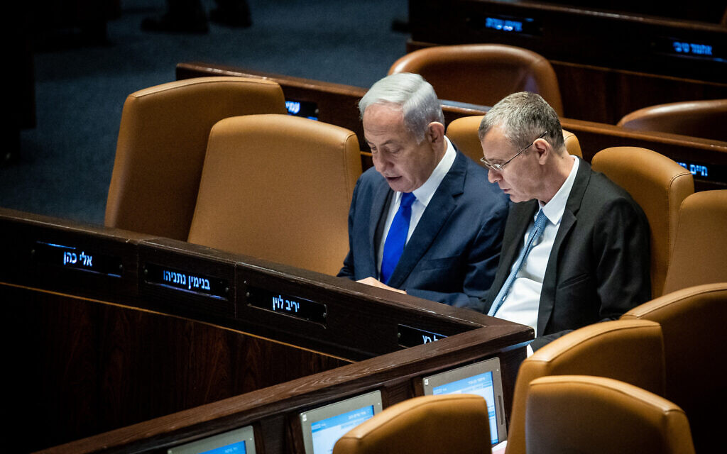 Prime Minister Benjamin Netanyahu, left, and Justice Minister Yariv Levin, right, on the Knesset floor, June 7, 2023. (Oren Ben Hakoon/Flash90) Prime Minister Benjamin Netanyahu, left, and Justice Minister Yariv Levin, right, on the Knesset floor, June 7, 2023. (Oren Ben Hakoon/Flash90)