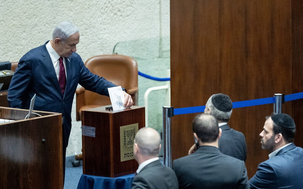 Prime Minister Benjamin Netanyahu votes to nominate lawmakers to sit on the Judicial Selection Committee, June 14, 2023. (Yonatan Sindel/Flash90) Prime Minister Benjamin Netanyahu votes to nominate lawmakers to sit on the Judicial Selection Committee, June 14, 2023. (Yonatan Sindel/Flash90)