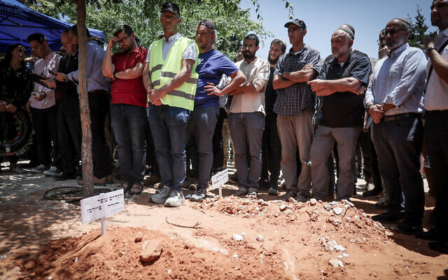 Friends and family attend the funeral of 64-year-old Ofer Fayerman, who was killed in a terror attack near the West Bank settlement of Eli, at the cemetery in Eli, on June 21, 2023. (Yonatan Sindel/Flash90) Friends and family attend the funeral of 64-year-old Ofer Fayerman, who was killed in a terror attack near the West Bank settlement of Eli, at the cemetery in Eli, on June 21, 2023. (Yonatan Sindel/Flash90)