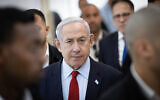 Prime Minister Benjamin Netanyahu arrives at the Jerusalem District Court to listen to video testimony from businessman Arnon Milchan in the prime minister's corruption trial, June 26, 2023. (Alex Kolomoisky/Pool)