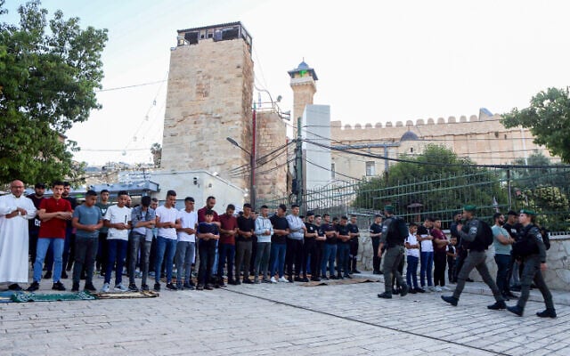 Palestinians attend Eid al-Adha prayers at the Ibrahimi mosque, in the West Bank city of Hebron, June 28, 2023. (Wisam Hashlamoun/Flash90)