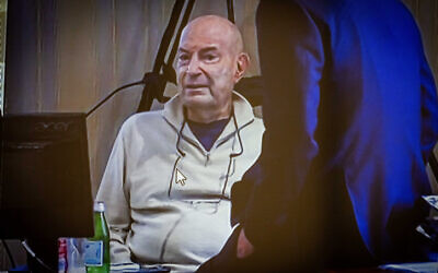 Businessman Arnon Milchan seen on a screen before his testimony in Netanyahu's Case 1000 corruption trial, in Brighton, June 29, 2023. (Yonatan Sindel/Flash90)