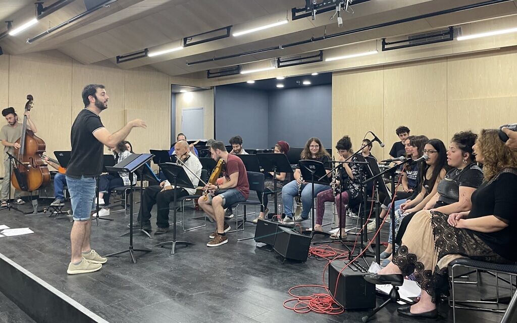 Conductor Ido Marko (far left) during an early June 2023 rehearsal of the Integrative Orchestra, comprising students from the Jerusalem Academy of Music and Dance and Shekel, a Jerusalem program for adults with special needs (Jessica Steinberg/Times of Israel) Conductor Ido Marko (far left) during an early June 2023 rehearsal of the Integrative Orchestra, comprising students from the Jerusalem Academy of Music and Dance and Shekel, a Jerusalem program for adults with special needs (Jessica Steinberg/Times of Israel)