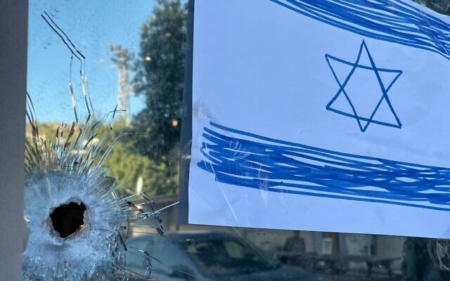 A bullet hole in the window of the Hummus Eliyahu restaurant outside of the Eli West Bank settlement, June 26, 2023. (Jeremy Sharon/Times of Israel)