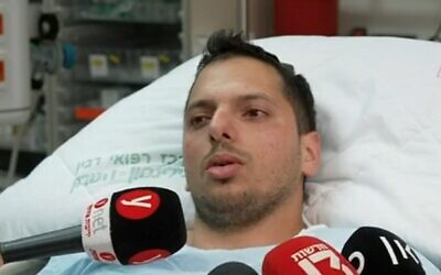 Morel Nikel, who shot dead a terrorist at a gas station near the settlement of Eli, and was shot and wounded in the exchange of fire, speaks from his hospital bed, June 20, 2023. (Channel 12 screenshot; Used in accordance with Clause 27a of the Copyright Law)