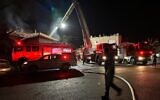 Firefighters at the scene of a suspected case of arson of a policeman's home in the northern town of Rehaniya, June 8, 2023. (Fire and Rescue Services)