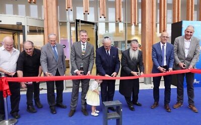 Ribbon cutting at official opening of Helmsley Cancer Center at Shaare Zedek Medical Center. Those pictured include architect Tye Farrow (fourth from left), Shaare Zedek president Prof. Jonathan Halevy (fifth from left), Shaare Zedek director general Prof. Ofer Merin (second from right), and Helmsley Cancer Center director Prof. Nir Peled (far right). June 1, 2023.(Efrat Farjun)