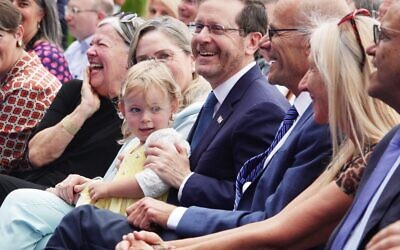 President Isaac Herzog (center) enjoys himself at opening event for new Helmsley Cancer Center at Shaare Zedek Medical Center, Jerusalem, June 1, 2023. (Efrat Farjun)