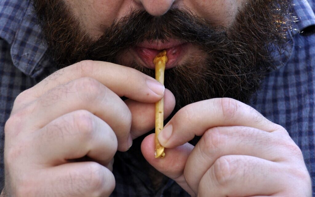Hebrew University post-doctoral fellow Dr. Laurent Davin plays a recreated 12,000-year-old flute discovered in northern Israel. (credit Laurent Davin)