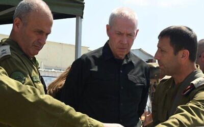 Defense Minister Yoav Gallant (C) at the scene, the day after a terror attack near the West Bank settlement of Eli, on June 21, 2023 (Ariel Hermoni/Defense Ministry)