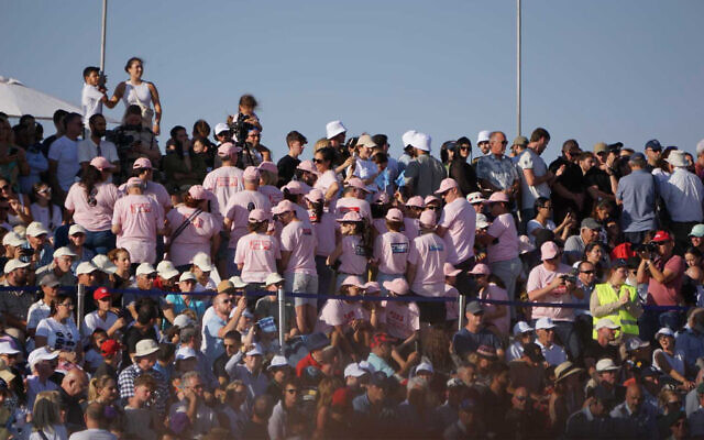 Members of the crowd turn their backs on Prime Minister Benjamin Netanyahu as he speaks at a pilot graduation ceremony at the Hatzerim Air Base, June 29, 2023. (Emanuel Fabian/Times of Israel)