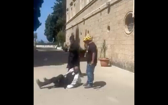 A man hits a Jewish man in video said to show an incident outside a Haifa monastery. (Screenshot, Used in accordance with Clause 27a of the Copyright Law) A man hits a Jewish man in video said to show an incident outside a Haifa monastery. (Screenshot, Used in accordance with Clause 27a of the Copyright Law)