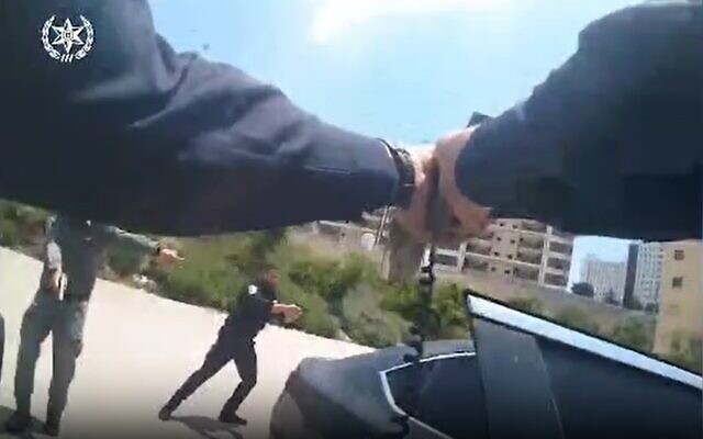 Bodycam footage of police arresting three suspects in the parking lot of the Holy Family Hospital in Nazareth, June 11, 2023. (Israel Police) Bodycam footage of police arresting three suspects in the parking lot of the Holy Family Hospital in Nazareth, June 11, 2023. (Israel Police)