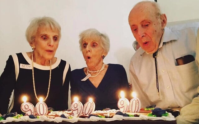 Betty Woolf, left, and her siblings Minna and Joseph celebrate their 90th birthday in 2017. (Courtesy/Jason Paladino via JTA) Betty Woolf, left, and her siblings Minna and Joseph celebrate their 90th birthday in 2017. (Courtesy/Jason Paladino via JTA)