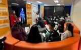 Students listen to testimony from the USC Shoah Foundation 'Dimensions in Testimony' project while at 'We Are White Plains,' a Holocaust education exhibit designed by Common Circles, spring 2023 (courtesy)