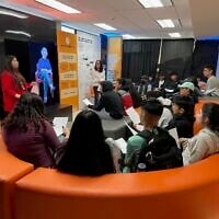 Students listen to testimony from the USC Shoah Foundation 'Dimensions in Testimony' project while at 'We Are White Plains,' a Holocaust education exhibit designed by Common Circles, spring 2023 (courtesy)