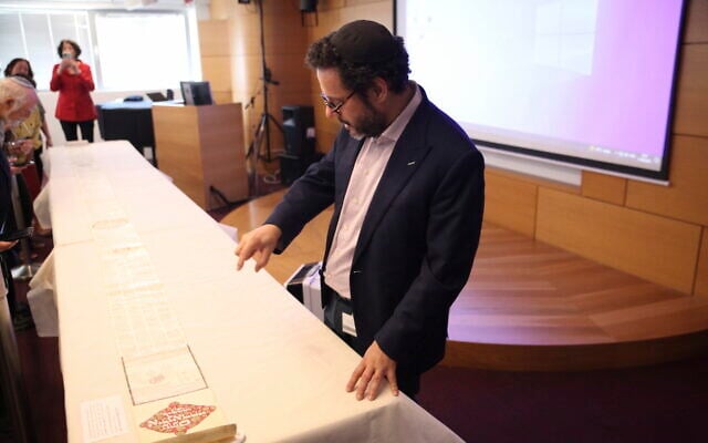 Dr. Haim Neria with the longest 'ilan' scroll in the world at the National Library of Israel in Jerusalem, June 11, 2023. (Uri Barkat)