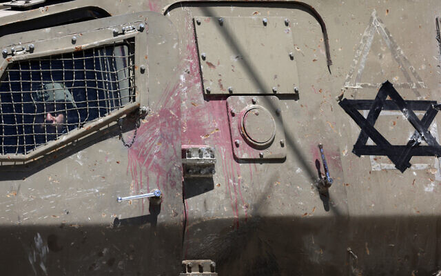An Israeli soldier looks out of the window of an armored personnel carrier in the West Bank village of Orif, south of Nablus, on June 29, 2023. (Jaafar ASHTIYEH / AFP) An Israeli soldier looks out of the window of an armored personnel carrier in the West Bank village of Orif, south of Nablus, on June 29, 2023. (Jaafar ASHTIYEH / AFP)