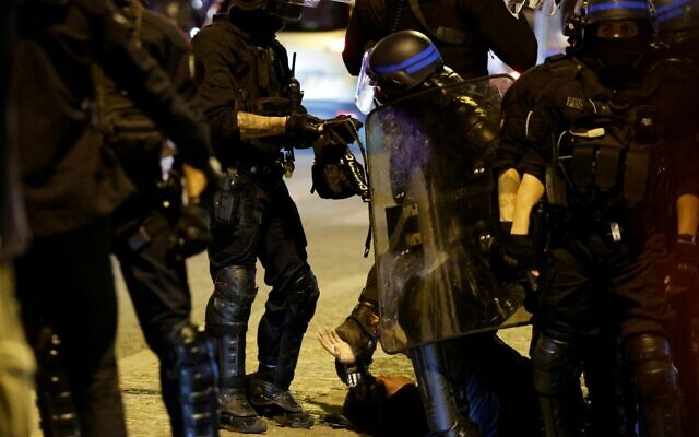 French police officers detain a demonstrator in Paris on July 2, 2023, five days after a 17-year-old man was killed by police in Nanterre, a western suburb of Paris. (Ludovic MARIN / AFP)