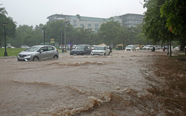 Vehicles make their way through a waterlogged road during heavy rainfall in Chandigarh on July 10, 2023 (AFP)