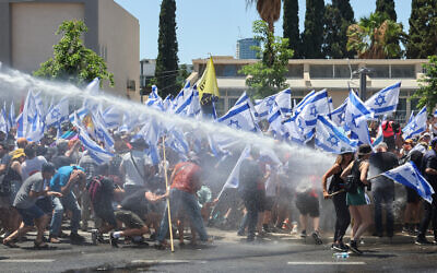 Police fire water cannons to disperse a protest against the judicial overhaul in Tel Aviv, on July 11, 2023. (Jack Guez/AFP)