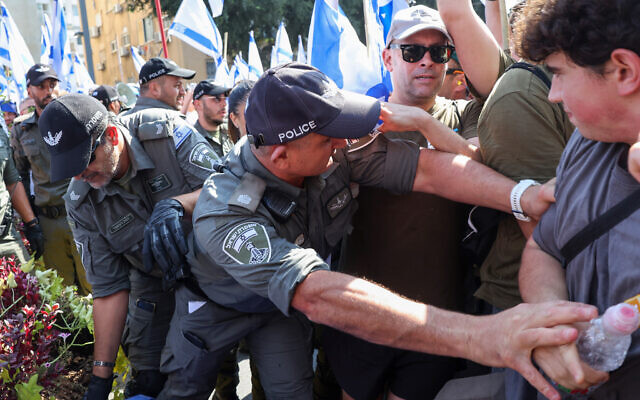 Police disperse demonstrators protesting the government's judicial overhaul plans, in Tel Aviv, July 18, 2023. (JACK GUEZ/AFP) Police disperse demonstrators protesting the government's judicial overhaul plans, in Tel Aviv, July 18, 2023. (JACK GUEZ/AFP)