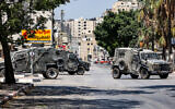 Israeli army vehicles are seen during a raid in al-Ain refugee camp in the West Bank city of Nablus, July 26, 2023. (Zain Jaafar/AFP)