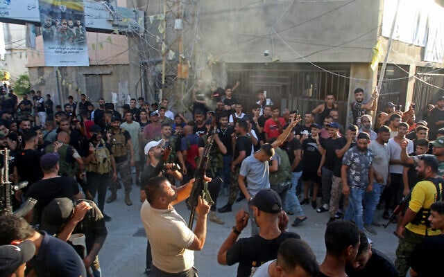 Militants fire into the air during the funeral of two Fatah commanders at a Palestinian refugee camp in the southern Lebanese port city of Tyre on July 31, 2023. (Mahmoud Zayyat/AFP) Militants fire into the air during the funeral of two Fatah commanders at a Palestinian refugee camp in the southern Lebanese port city of Tyre on July 31, 2023. (Mahmoud Zayyat/AFP)