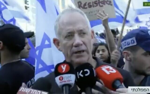 National Unity leader Benny Gantz speaks to reporters during an anti-government demonstration on Kaplan Street in Tel Aviv, July 11, 2023. (Twitter screenshot; used in accordance with Clause 27a of the Copyright Law)