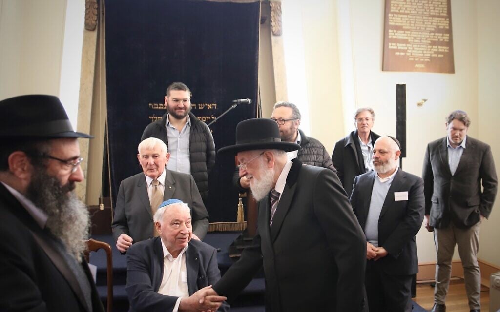 Israel's former chief Ashkenazi rabbi Yisrael Meir Lau shakes hands with Holocaust survivor Felix Goldschmied at the Launceston Synagogue in Launceston, Australia, July 12, 2023. (Mishka Gora via JTA)