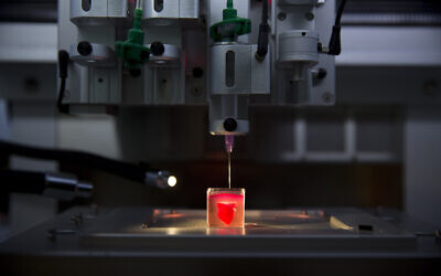 A 3D printer prints a heart with human tissue during a presentation at Tel Aviv University, in Tel Aviv, Israel, Monday, April 15, 2019. (AP/Oded Balilty)