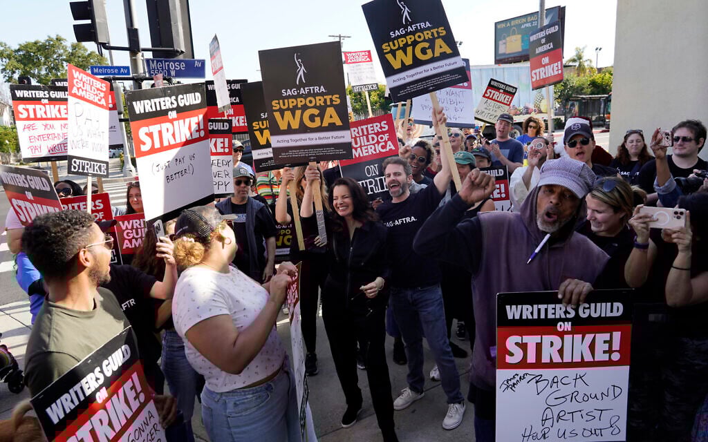 Fran Drescher, center, president of SAG-AFTRA, joins Writers Guild of America rally participants outside Paramount Pictures studio, Monday, May 8, 2023, in Los Angeles. (AP Photo/Chris Pizzello)