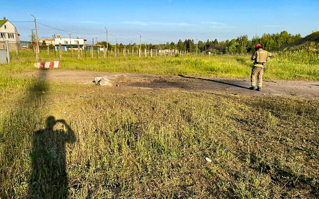 Illustrative: In this handout photo released by Moscow Region Governor Andrei Vorobyev's Telegram channel on June 21, 2023, an emergency services employee walks near the site where a drone crashed, near Kalininets, outside Moscow, Russia. (Moscow Region Governor Andrei Vorobyev telegram channel via AP) Illustrative: In this handout photo released by Moscow Region Governor Andrei Vorobyev's Telegram channel on June 21, 2023, an emergency services employee walks near the site where a drone crashed, near Kalininets, outside Moscow, Russia. (Moscow Region Governor Andrei Vorobyev telegram channel via AP)