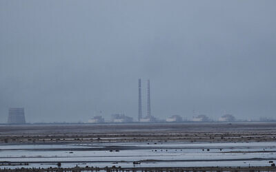 The Zaporizhzhia nuclear power plant, Europe's largest, is seen in the background of the shallow Kakhovka Reservoir in Energodar, Russian-occupied Ukraine, June 27, 2023. (Libkos/AP) The Zaporizhzhia nuclear power plant, Europe's largest, is seen in the background of the shallow Kakhovka Reservoir in Energodar, Russian-occupied Ukraine, June 27, 2023. (Libkos/AP)