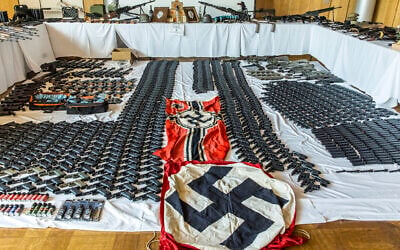 This picture provided by the Austrian Interior Ministry on June 29, 2023 shows secured weapons, objects and ammunitions and swastika flags. (BMI/Gerd Pachauer via AP) This picture provided by the Austrian Interior Ministry on June 29, 2023 shows secured weapons, objects and ammunitions and swastika flags. (BMI/Gerd Pachauer via AP)