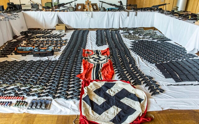 This picture provided by the Austrian Interior Ministry on June 29, 2023 shows secured weapons, objects and ammunitions and swastika flags. (BMI/Gerd Pachauer via AP) This picture provided by the Austrian Interior Ministry on June 29, 2023 shows secured weapons, objects and ammunitions and swastika flags. (BMI/Gerd Pachauer via AP)