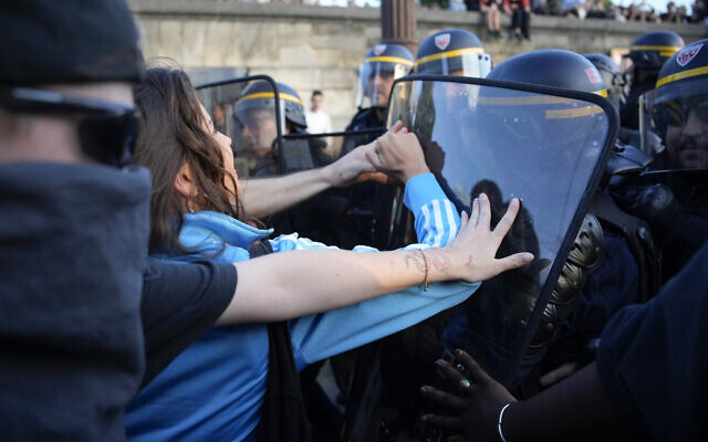 Police officers face protesters on Concorde square during a protest in Paris, France, June 30, 2023. (Lewis Joly/AP) Police officers face protesters on Concorde square during a protest in Paris, France, June 30, 2023. (Lewis Joly/AP)