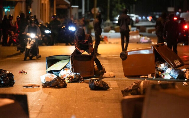 Protesters block a street with garbage cans in Colombes, outside Paris, France, July 1, 2023  (AP Photo/Lewis Joly)