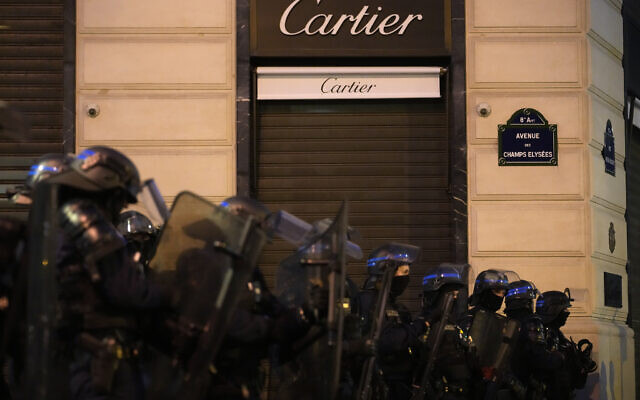 Police officers stand guard on the Champs Elysees in Paris, Saturday, July 1, 2023. (AP/Christophe Ena)