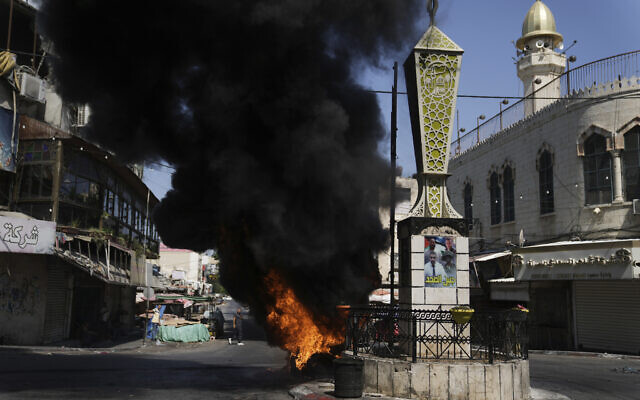 Tires burn during an Israeli military raid in the Jenin refugee camp in the West Bank, July 3, 2023 (AP Photo/Nasser Nasser) Tires burn during an Israeli military raid in the Jenin refugee camp in the West Bank, July 3, 2023 (AP Photo/Nasser Nasser)