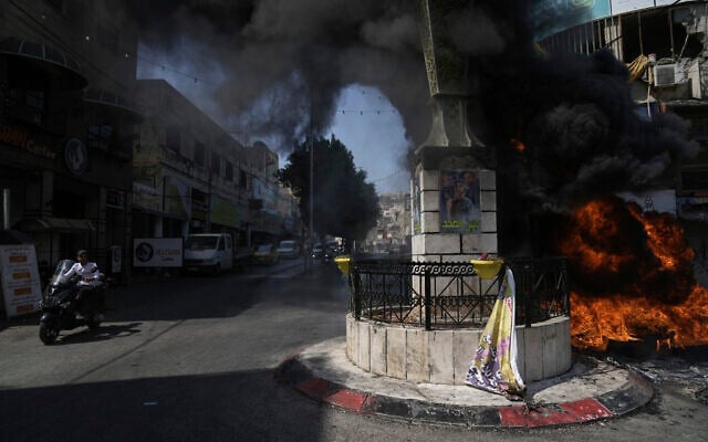 Tires burn during an Israeli military raid in the Jenin refugee camp in the West Bank, Monday, July 3, 2023.(AP Photo/Nasser Nasser) Tires burn during an Israeli military raid in the Jenin refugee camp in the West Bank, Monday, July 3, 2023.(AP Photo/Nasser Nasser)