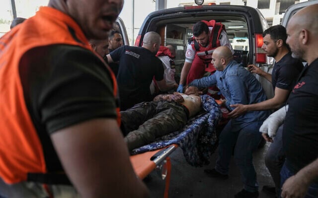 An injured Palestinian is carried into a hospital during an Israeli military raid in the Jenin refugee camp in the West Bank, Monday, July 3, 2023. (AP Photo/Nasser Nasser) An injured Palestinian is carried into a hospital during an Israeli military raid in the Jenin refugee camp in the West Bank, Monday, July 3, 2023. (AP Photo/Nasser Nasser)